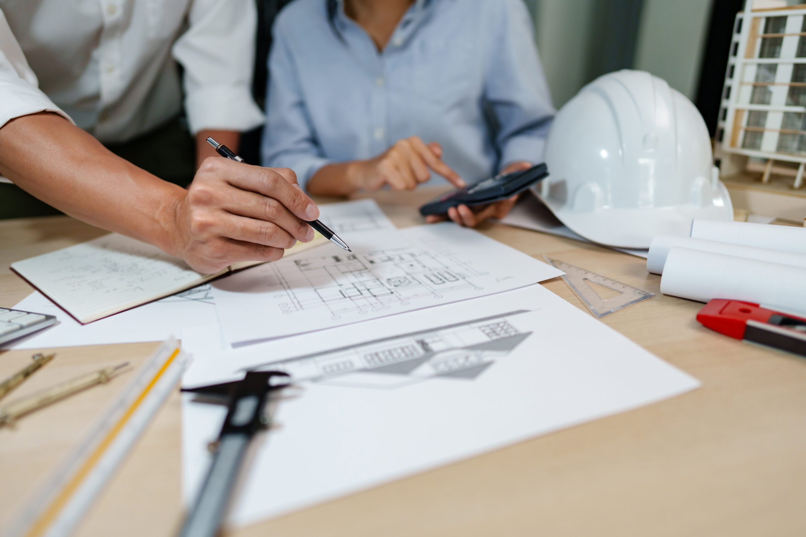 architects interior designer working with blue prints and documents for a home renovation for house design